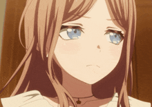 a close up of a girl 's face with long hair and blue eyes