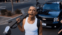 a man in a white tank top is holding a gun in front of a chevrolet suv with the word brothers on the license plate