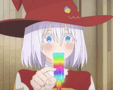a girl with white hair and a red hat is holding a rainbow colored stick in her mouth