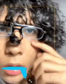 a close up of a person wearing glasses with a blue stripe on their mouth