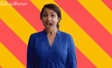 a woman in a blue shirt is making a surprised face in front of a colorful background with college humor written on it