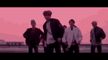a group of young men are standing next to each other on a rooftop .