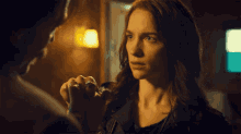 a woman with a ring on her finger looks at another woman