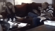 a blurry picture of a man sitting on a couch