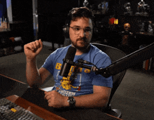 a man sitting in front of a microphone with the words very unimpressed applause written below him