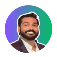 a man with a beard is smiling in front of a blue and green circle