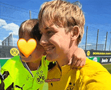 a boy wearing a yellow shirt with bvb on the front