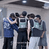 a group of young men are huddled together with one wearing a number 88 shirt