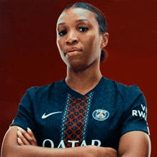 a woman wearing a jersey that says qatar on the front