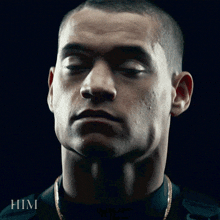 a close up of a man 's face with the word him on the bottom right