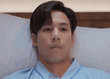 a man in a hospital gown is laying on a bed