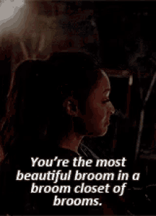 a woman is standing in a dark room with a quote that says you 're the most beautiful broom