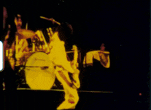 a blurry picture of a person playing a drum
