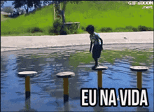 a boy stands on a row of stools in a puddle with the words eu na vida written below him