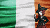 a girl in a witch hat stands in front of a flag