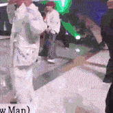 a group of people standing in a room with the word man on the bottom left