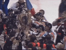 a group of hockey players are holding up a trophy with the number 96 on the back