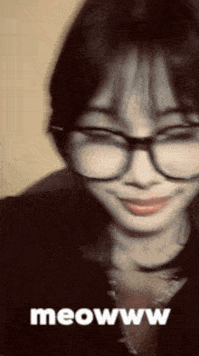 a woman wearing glasses says meowww on the bottom of the image