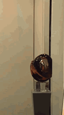 a woman in a futuristic outfit is holding a sphere