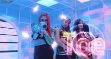 a group of girls are standing next to each other holding guns in front of the word love .