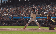 a baseball player getting ready to hit a ball in front of a crowd with chevrolet banners