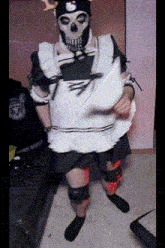 a person dressed in a maid costume with a skull mask on their face