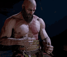 a bald man with a beard is holding his chest with his hands