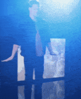 a blurry picture of a man in a blue light
