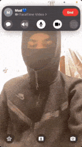 a person wearing a nike jacket is on a video call with mud