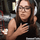 a woman wearing glasses and headphones with sweettails written on the bottom right