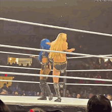 a woman in a wrestling ring with a watermark that says the next thing