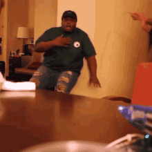 a man in a green shirt with a soccer ball on it is dancing
