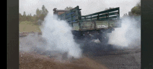 a truck with smoke coming out of it has a license plate that starts with o