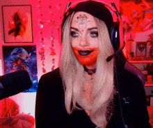 a woman with blood on her face is wearing headphones and a hat