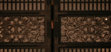 a man peeking through a door with a fancy design on it