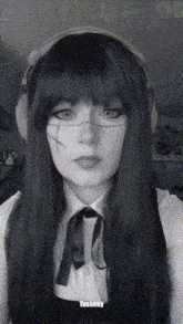 a black and white photo of a woman with tassery written on the bottom right corner