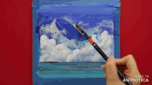 a person is holding a brush in front of a painting that says made in animatica