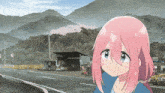 a girl with pink hair and blue eyes is standing on the side of the road