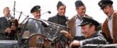 a group of men are standing around a car and one of them is wearing a hat with the letter s on it