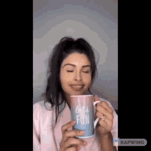 a woman is holding a mug that says let 's fun on it .