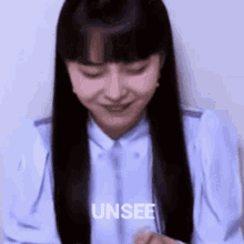a woman in a blue shirt is smiling and says unsee