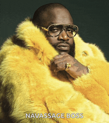 a man wearing glasses and a yellow fur coat with the name navassage boss below him
