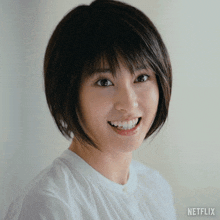 a woman wearing a white shirt with netflix written on the bottom right