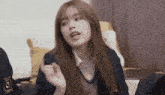 a young girl in a school uniform is making a funny face .