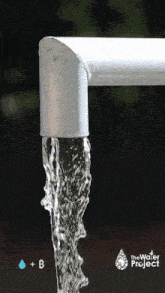 a faucet with water coming out of it and the water project logo