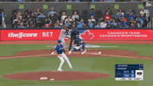 a baseball game is being played in front of an ad for the score bet