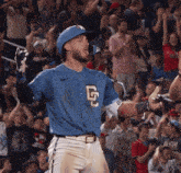 a baseball player wearing a blue jersey with the letter g on the front