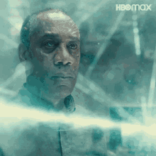 a man is looking out a window with hbo max written on the bottom right