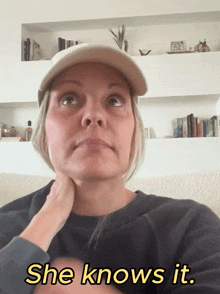 a woman wearing a hat says she knows it in yellow letters
