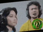 a man and a woman wearing headphones are singing in front of a green circle with the letter p on it